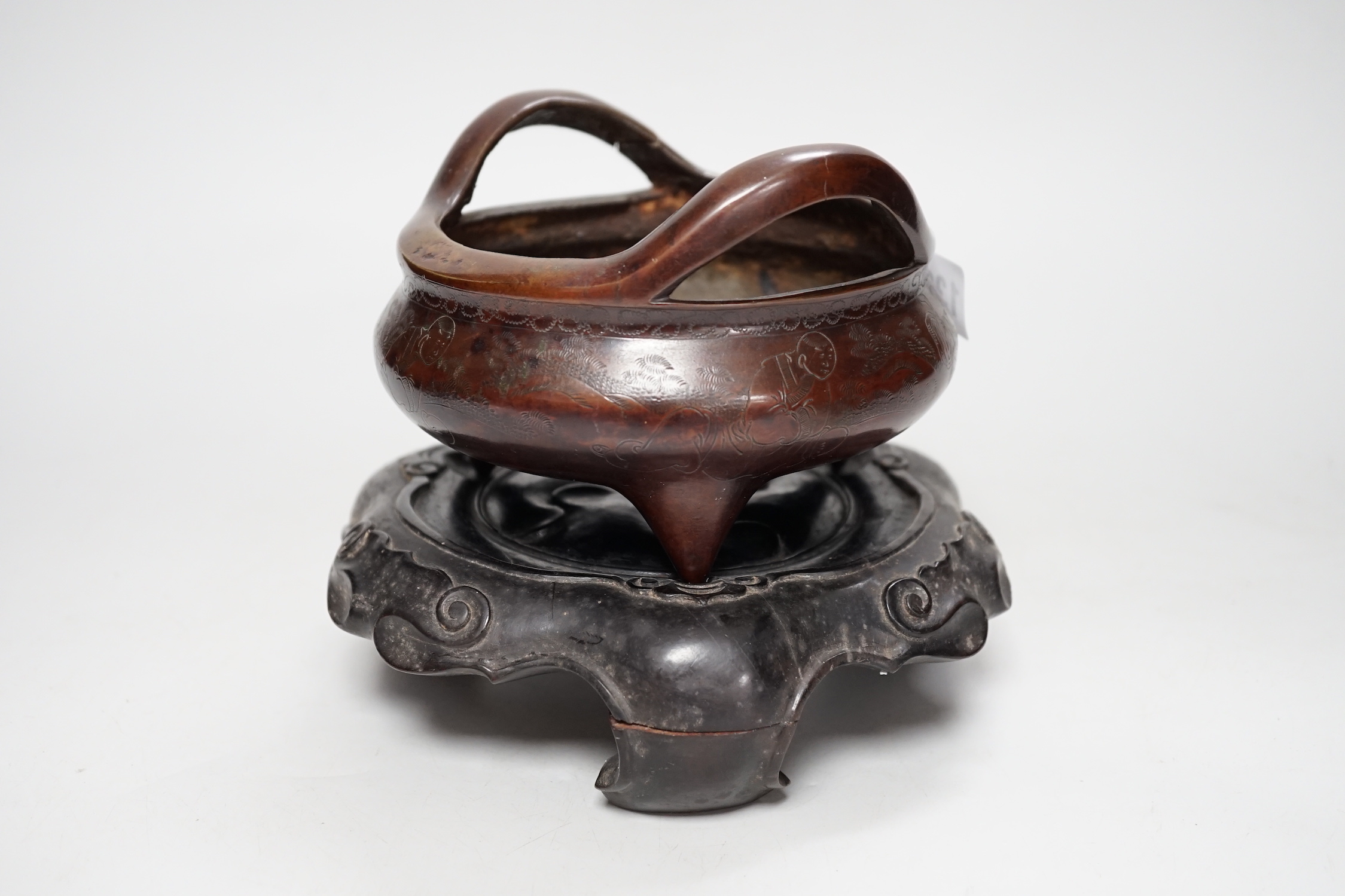 A Chinese bronze censer, with engraved detail, on hardwood stand, censer 16cm diam.